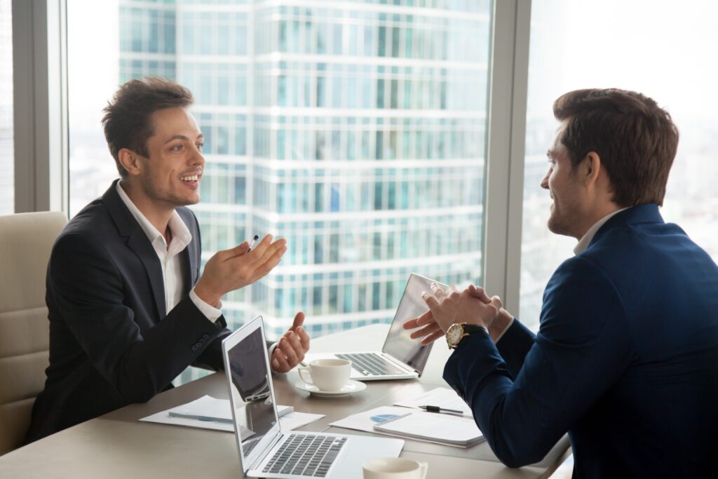 A business owner meets with an IT service provider to discuss outsourcing IT services.